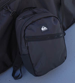 Black backpack with a Quiksilver logo.